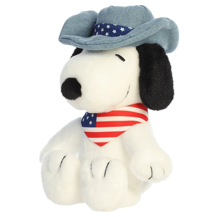 Snoopy plush toy with a cowboy hat and an American flag bandana on a white background