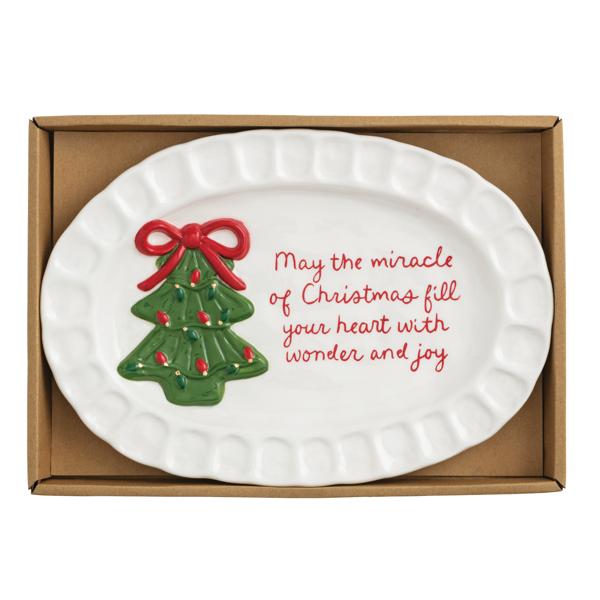 White ceramic platter with Christmas tree design and text in a cardboard box