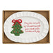 White ceramic platter with Christmas tree design and text in a cardboard box