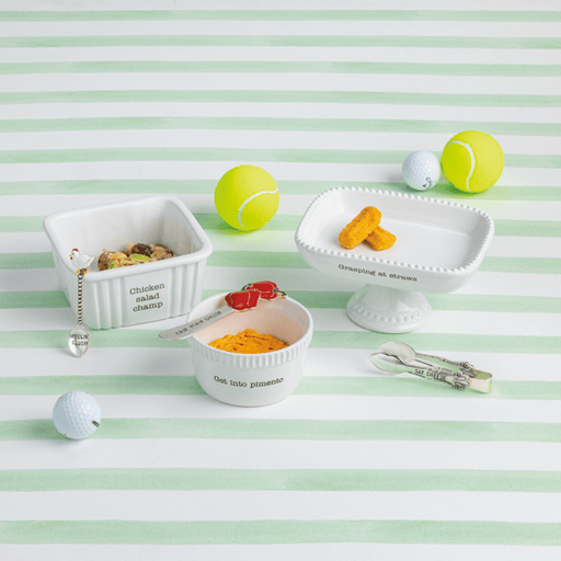 Pet toys and treats on a striped green and white background