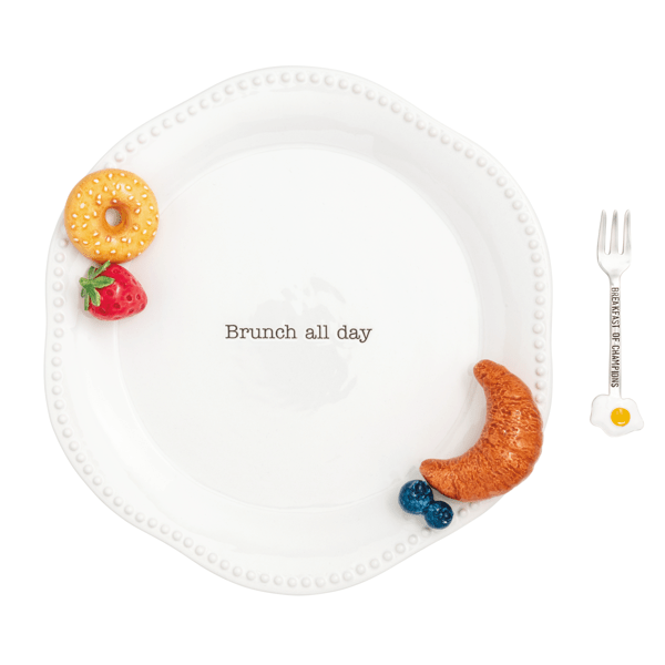 White plate with decorative food items and a fork on a white background