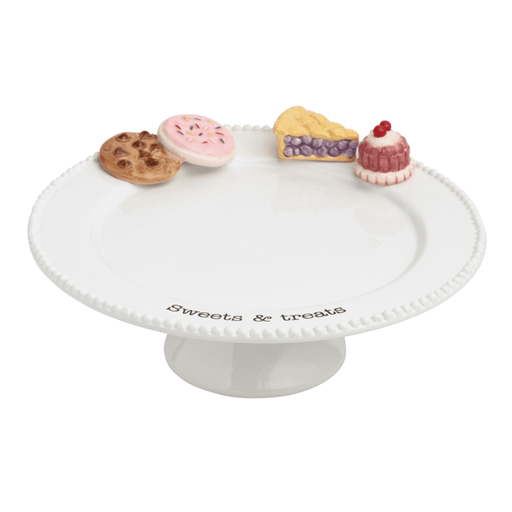 White cake stand with decorative sweet treats on a white background