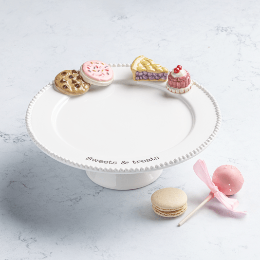 Decorative cake stand with small pastries on a light gray surface