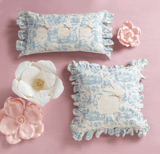 Decorative pillows with floral patterns on a pink background