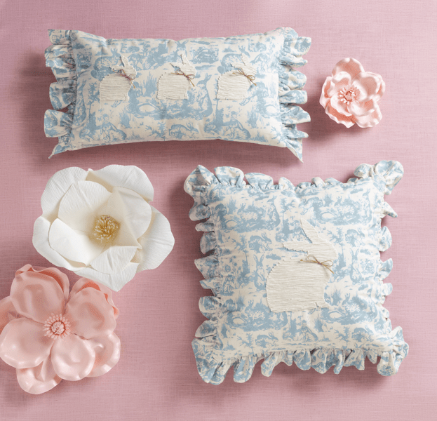 Decorative pillows with floral patterns on a pink background