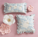 Decorative pillows with floral patterns on a pink background