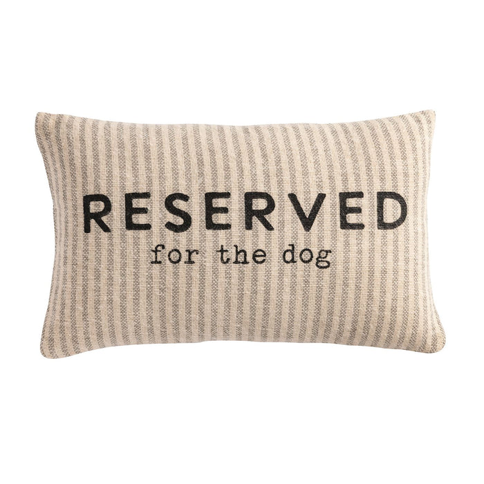 Beige pillow with 'Reserved for the dog' text on a white background