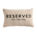 Beige pillow with 'Reserved for the dog' text on a white background