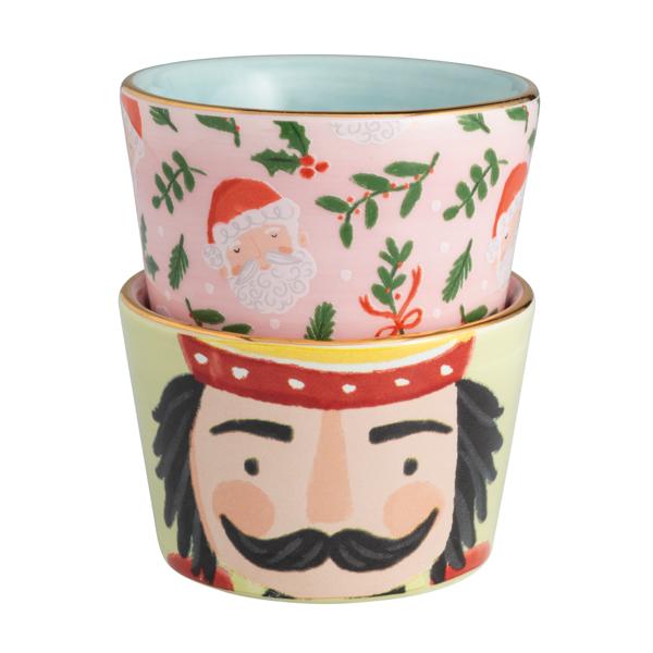 Two decorative ceramic pots with Christmas-themed designs stacked on a white background.