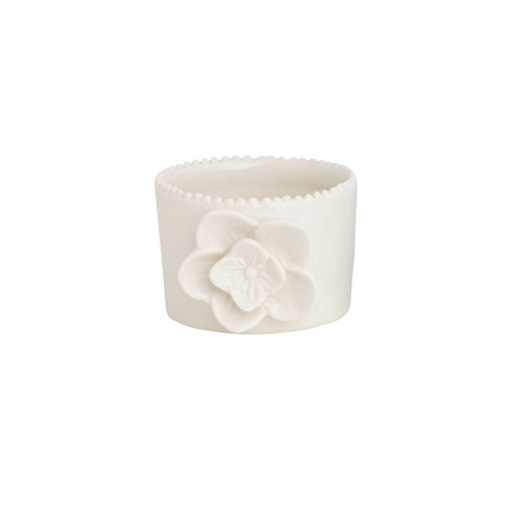 White ceramic cup with a floral design on a white background