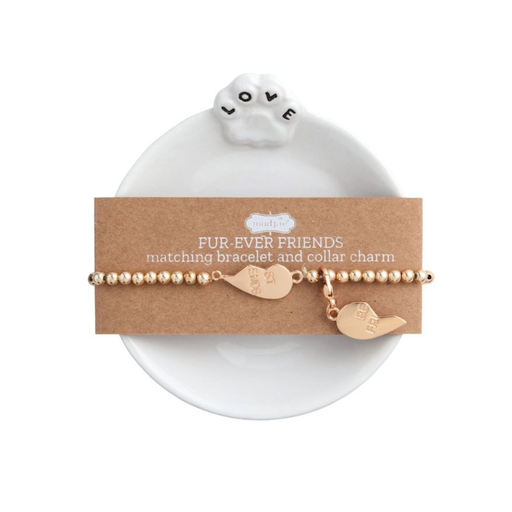 Gold bracelet and collar charm set on a white dish with 'Fur-Ever Friends' card.