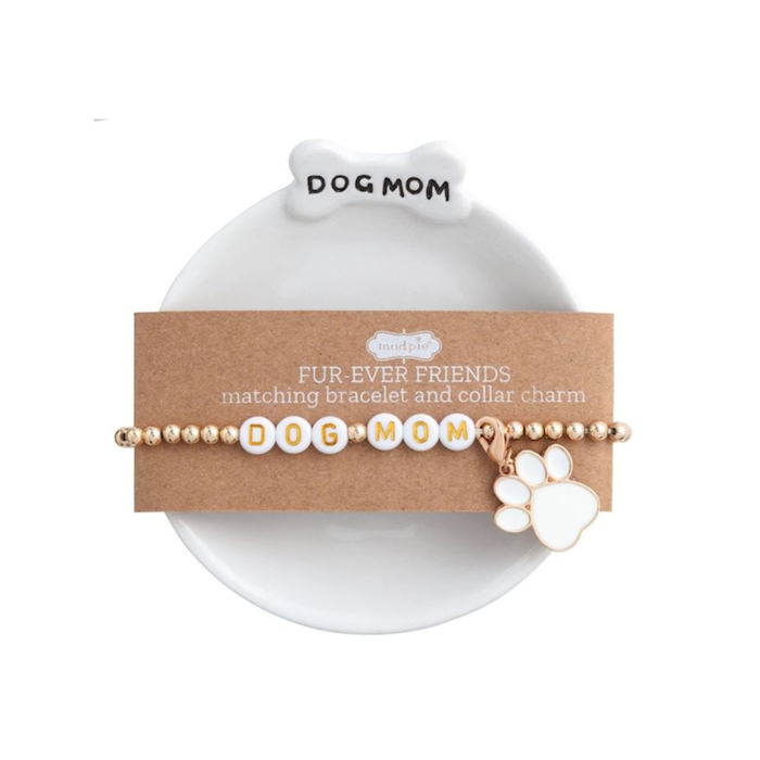 Bracelet and collar charm set with 'Dog Mom' on a card, displayed on a white plate.