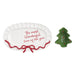 White decorative plate with red text and a green tree-shaped candle holder on a white background
