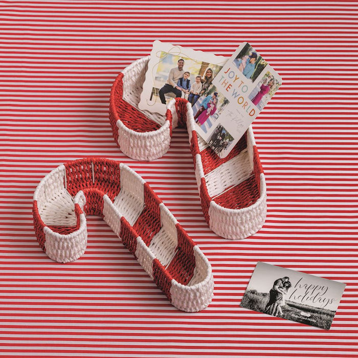 Red and white striped candy cane-shaped containers with photos on a red and white striped background