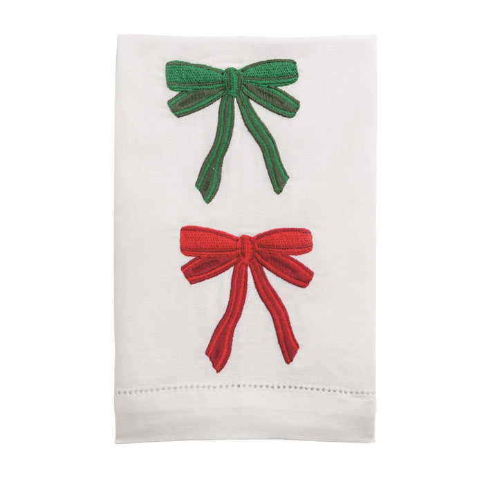 White towel with red and green embroidered bows on a white background