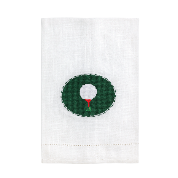 White towel with a green circle featuring a white golf ball and red and white flag on a white background