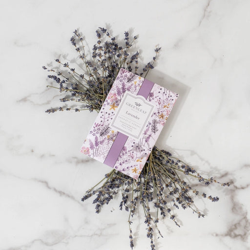 Lavender sachet with dried lavender flowers on a marble surface