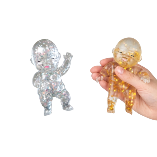 Two translucent glitter baby figurines shown on a white background, with one held in a hand to demonstrate scale. One figurine is entirely silver glitter, and the other is clear with gold glitter inside.