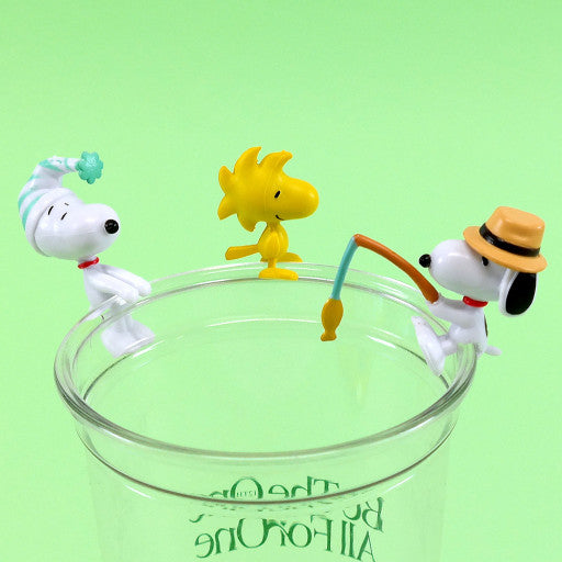 Three cartoon dog figurines on a clear glass with a green background
