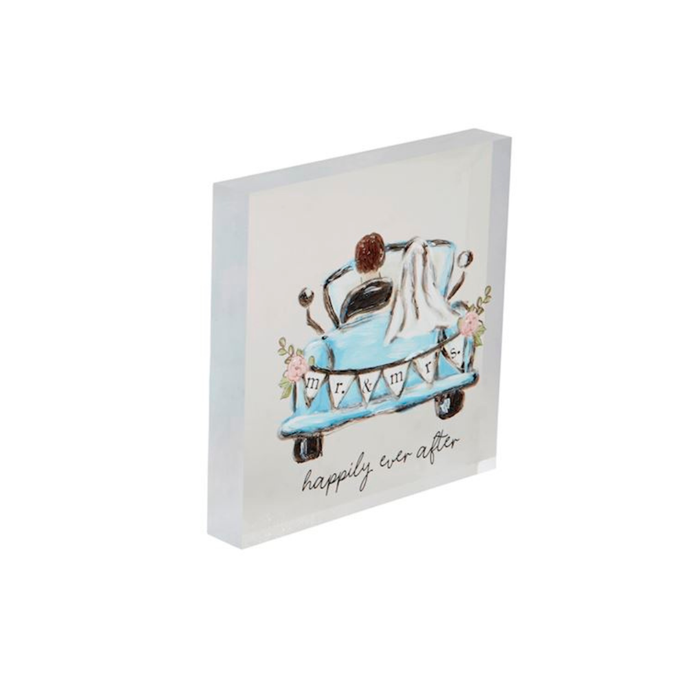 Decorative wall art with a wedding scene and 'happily ever after' text on a white background