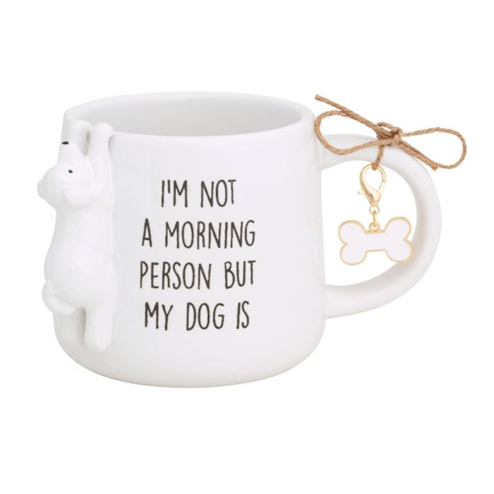 White mug with dog face design and 'I'm not a morning person but my dog is' text, featuring a bone-shaped keychain.