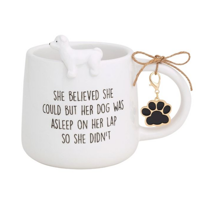 White ceramic mug with dog design and motivational quote, accompanied by a paw-shaped keychain on a white background.