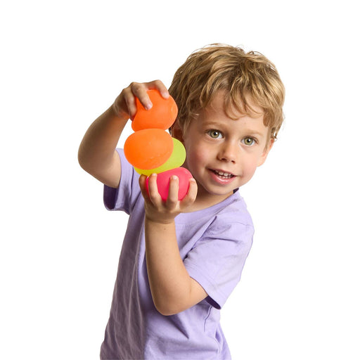 Child holding a colorful toy with a white background