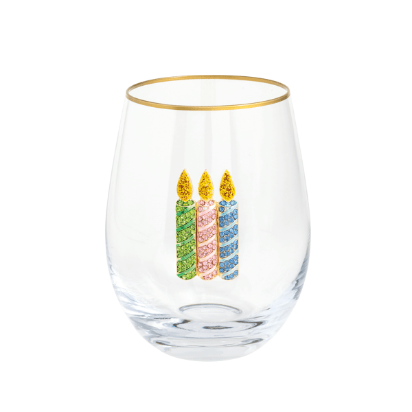 Clear glass with gold rim and colorful candle design on a white background