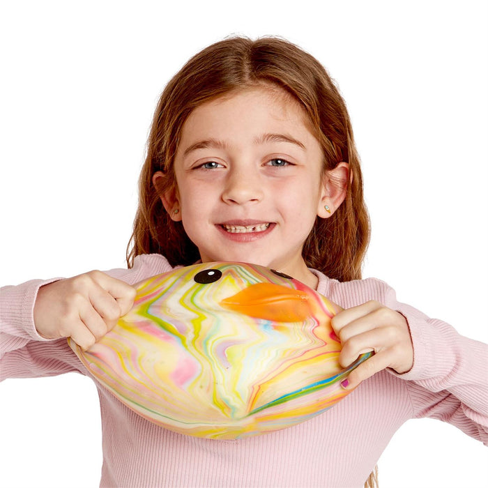 Young girl holding a colorful fish-shaped object against a white background