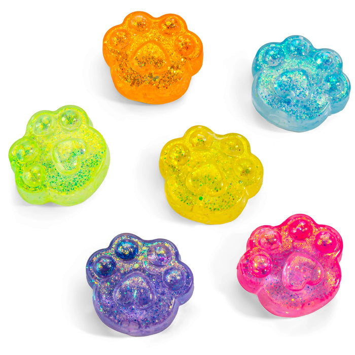 Set of colorful paw-shaped glittery toys on a white background
