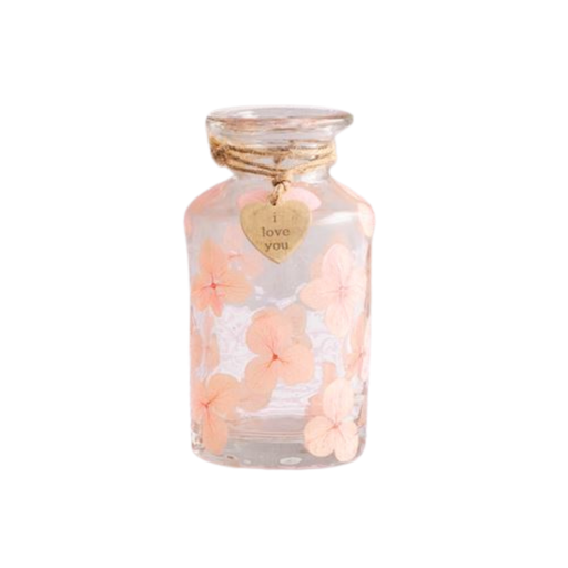 Glass jar with pink flowers and 'I love you' heart tag on a white background
