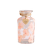 Glass jar with pink flowers and 'I love you' heart tag on a white background