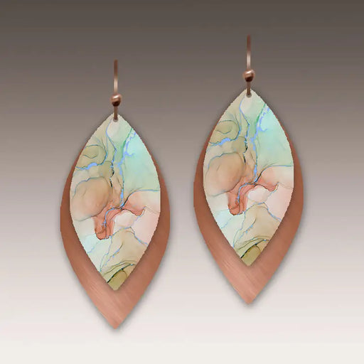 Pair of teardrop-shaped earrings with artistic design on a neutral background