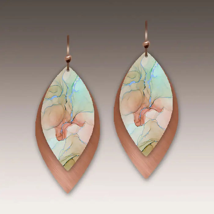 Pair of teardrop-shaped earrings with artistic design on a neutral background