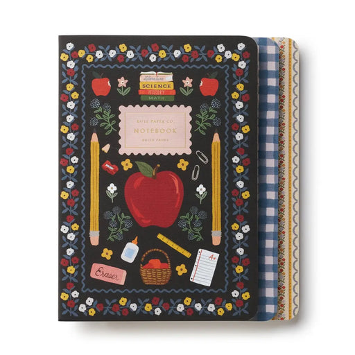A Little Paper Co. school-themed notebook with a black cover decorated with a colorful floral border, red apples, yellow pencils, and school supplies, shown with patterned paper inserts on the right side.