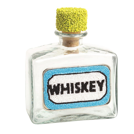 Small glass bottle labeled 'Whiskey' with a yellow cork on a white background