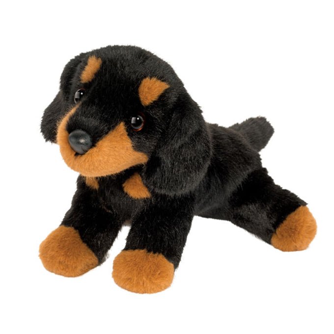 Plush toy dog with black and brown fur on a white background