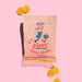 Packaging of Pippi Longstocking Gold Coins on a pink background with orange candy pieces.