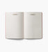 Open notebook with lined pages on a white background