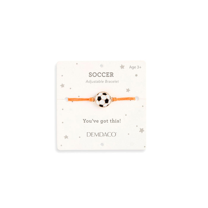Soccer-themed adjustable bracelet on a white card with 'DEMDACO' branding.