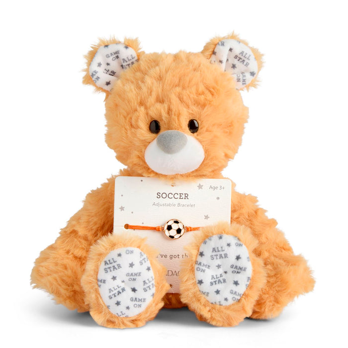 Plush teddy bear with a soccer-themed tag on a white background