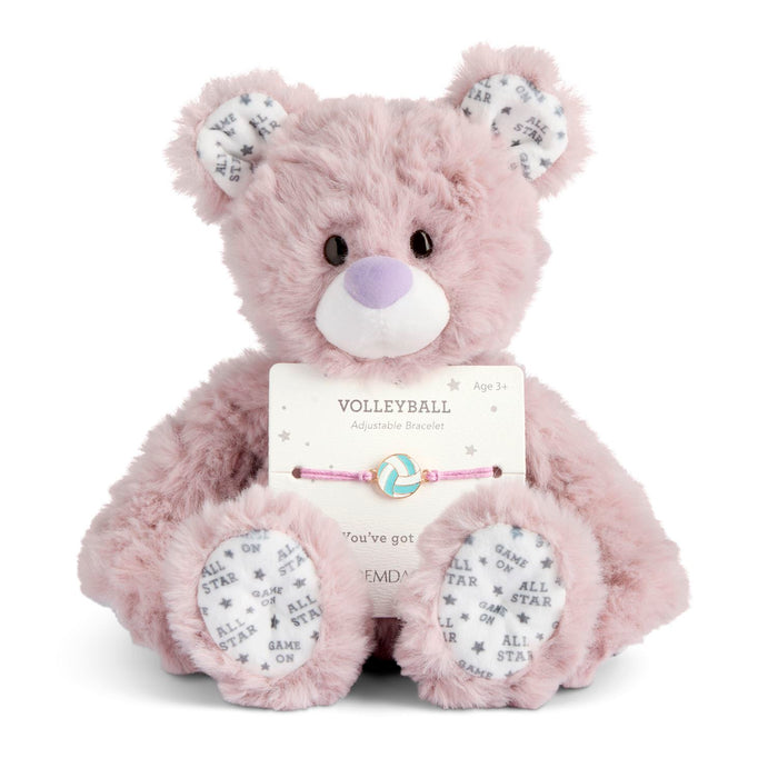 Pink teddy bear with a bracelet on a white background