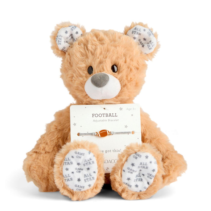 Plush teddy bear with a football-themed tag on a white background