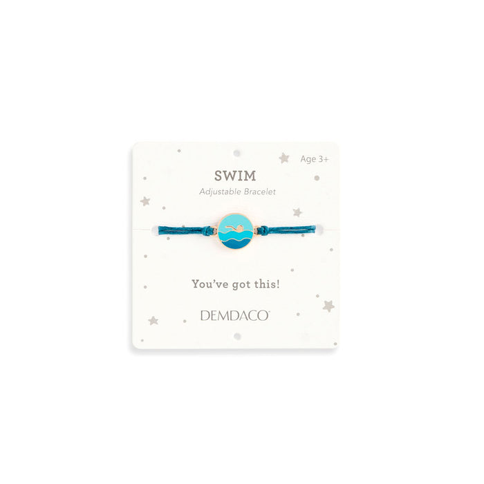 Bracelet with 'SWIM' design on a white card with text and Demdaco branding.