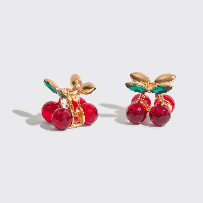 Cherry-themed earrings with gold and red design on a light gray background