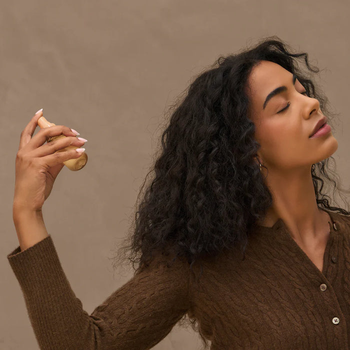 Woman holding a potato against a brown background
