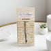 Kathina Auto Glam air freshener packaging on a white surface with decorative elements.