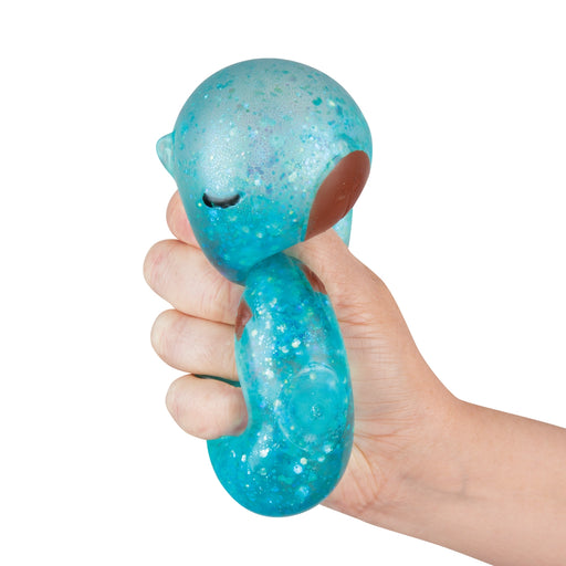Hand holding a blue glittery dog toy with a white background