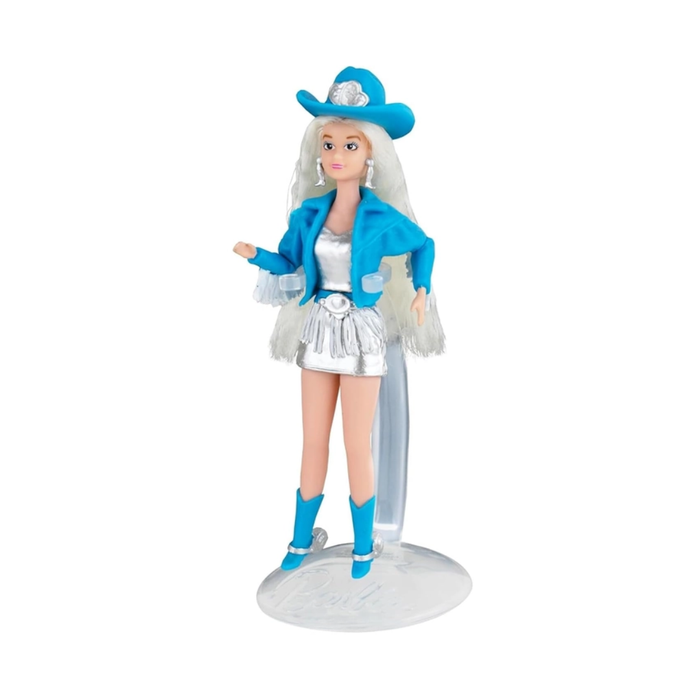 Toy doll with blue outfit and cowboy hat on a white background
