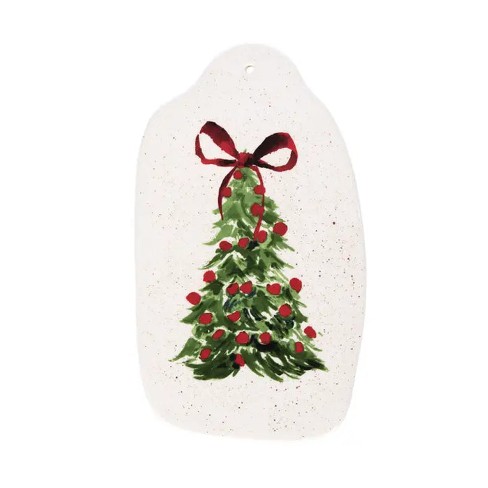 Decorative plate with a Christmas tree and red bow design on a white background